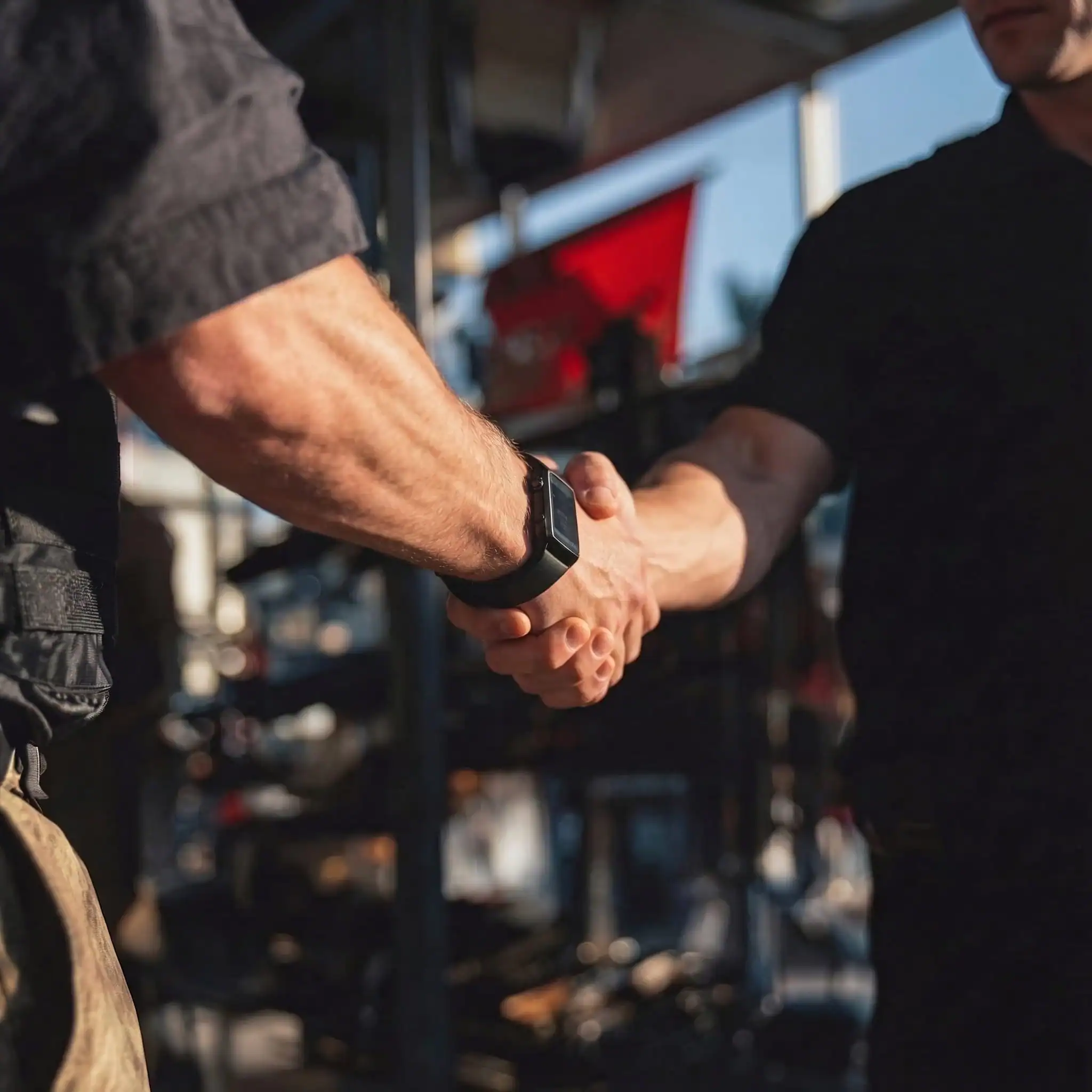 Two gun store owners shaking hands